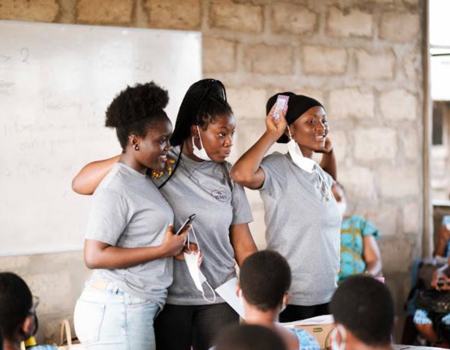 A mentor working with a small group of students